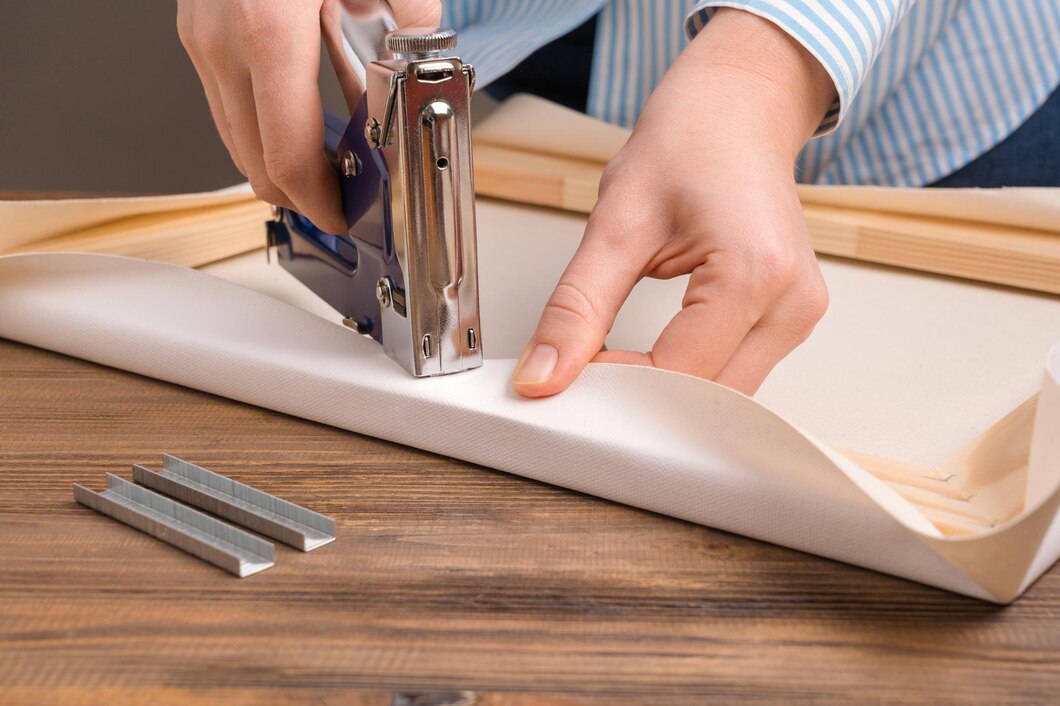 Tensioning the canvas with professional canvas pliers